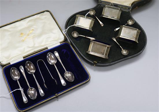 A set of four silver salts and spoons, blue glass liners, cased and a part set of teaspoons and tongs, cased